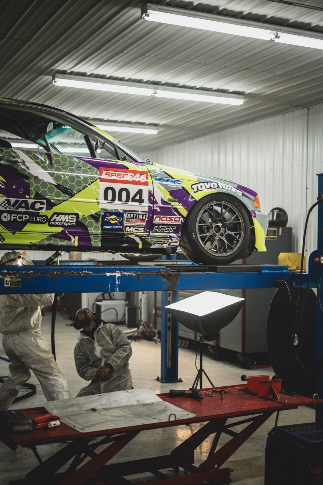 Race car elevated for dry ice blasting service